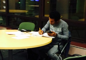 Darius Akente, biology major, studies for finals in the library.