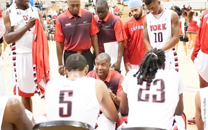 Head Coach Ronald St. John regrouping his players during a timeout. (Photo By VERITY ROLLINS)